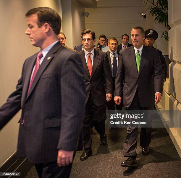 House Speaker John Boehner, right, and House Majority Leader from Eric Cantor center, walk into a Republican caucus meeting to consider the terms of...