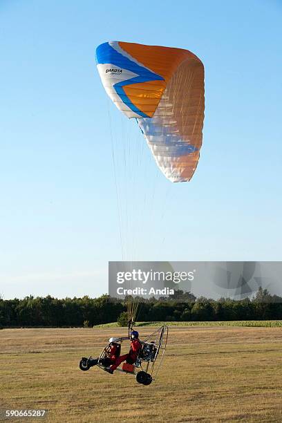 Motor paraglider in flight. Aerial sport, wing made of fabric. Paramotor -