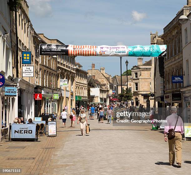 Shoppers in High Street, Stamford, Lincolnshire, England, UK.
