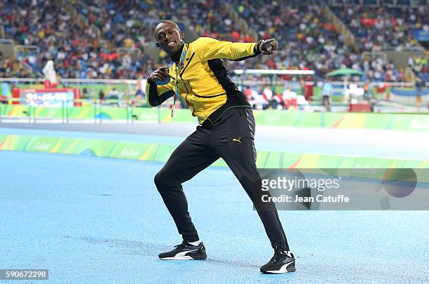 Gold medalist Usain Bolt of Jamaica poses during the medal ceremony for the Men's 100m on day 10 of the Rio 2016 Olympic Games at Olympic Stadium on...
