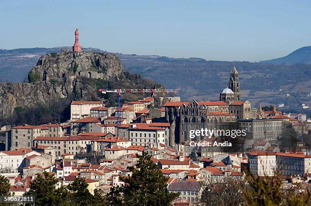 View of the city of Le Puy en Velay with the statue of "Notre Dame de France" on the "Rocher Corneille" rock and, below, the Roman cathedral...