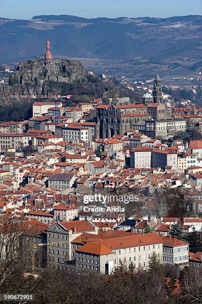 View of the city of Le Puy en Velay with the statue of "Notre Dame de France" on the "Rocher Corneille" rock and, below, the Roman cathedral...