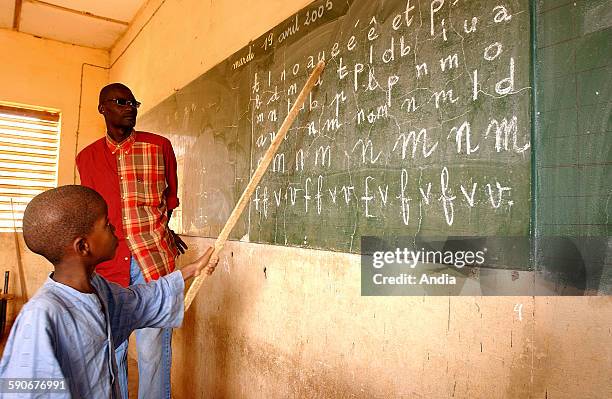 Abdoulaye Khady Diop public elementary school, at Thies in Senegal. Here, a pupil reading the letters written on the board by his teacher.