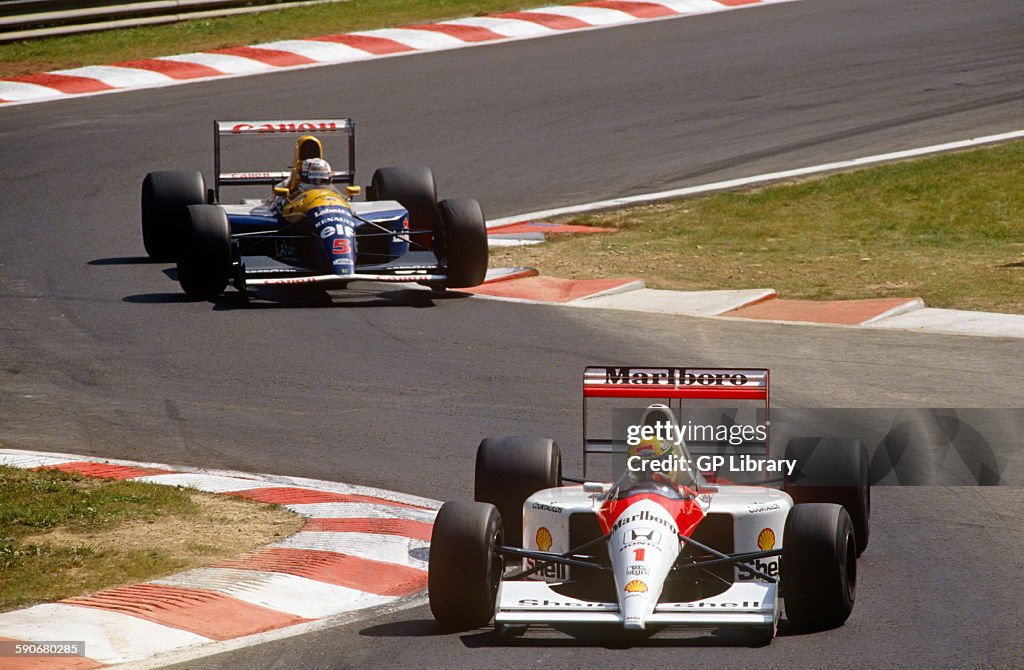 Ayrton Senna in a Marlboro Mclaren racing Nigel Mansell in a Williams Honda.