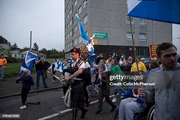 Musician with flaming bagpipes leading a spontaneous march to mobilise support for a pro-independence vote in the Craigmillar district of Edinburgh...