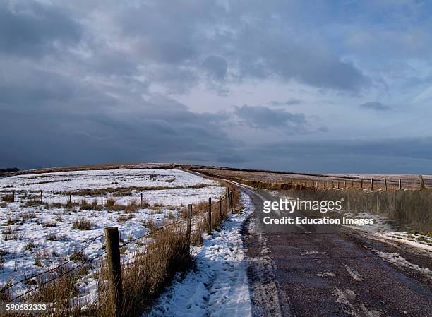 Narrow country road with snow, Exmoor, Somerset, UK.