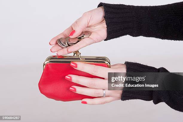 Woman holding money and a red purse.