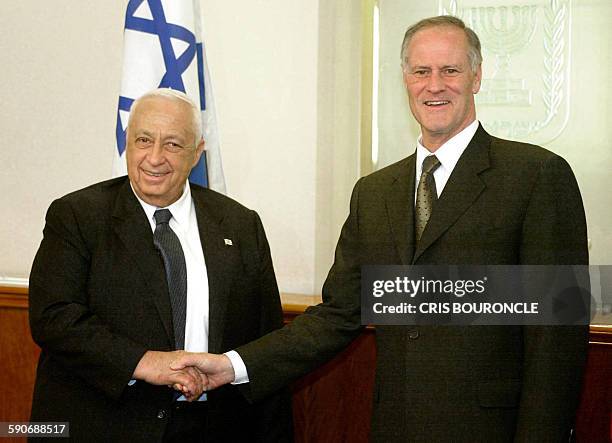 Canadian Foreign Minister Bill Graham shakes hands with Israeli leader Ariel Sharon at his office in Jerusalem on May 26, 2002. Graham who earlier in...