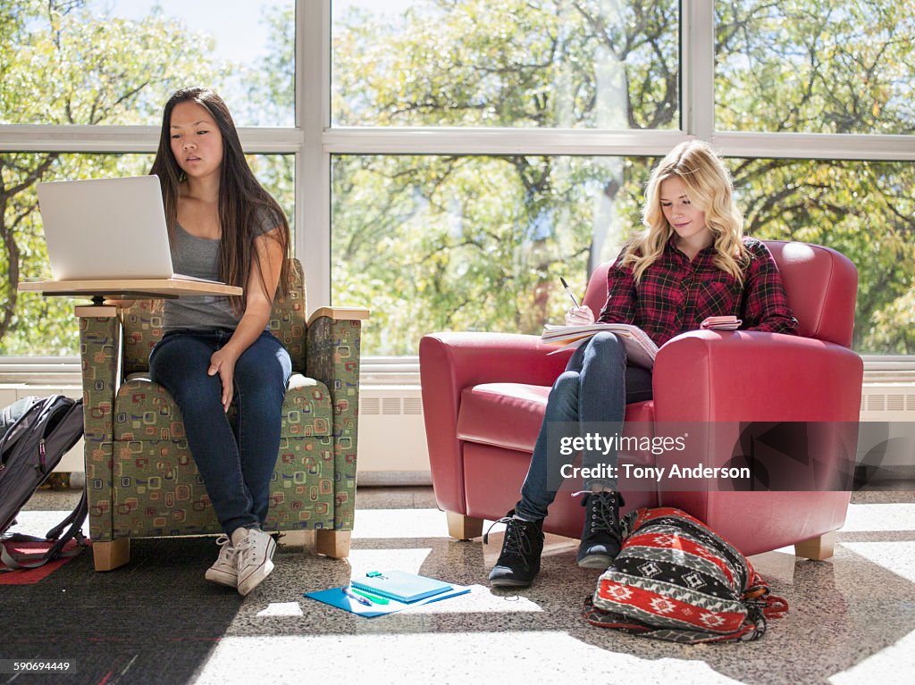 Young women studying for college classes