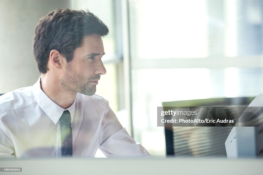 Office worker at work in cubicle