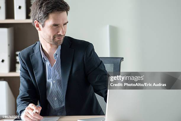 entrepreneur using laptop - suspicion office stock pictures, royalty-free photos & images