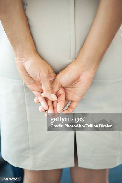womans clasped hands, rear view - hands behind back stock pictures, royalty-free photos & images