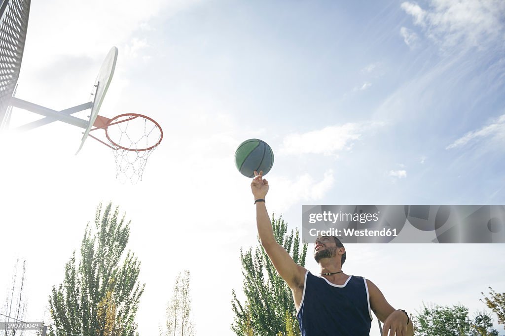 Man spinning a basketball on his finger