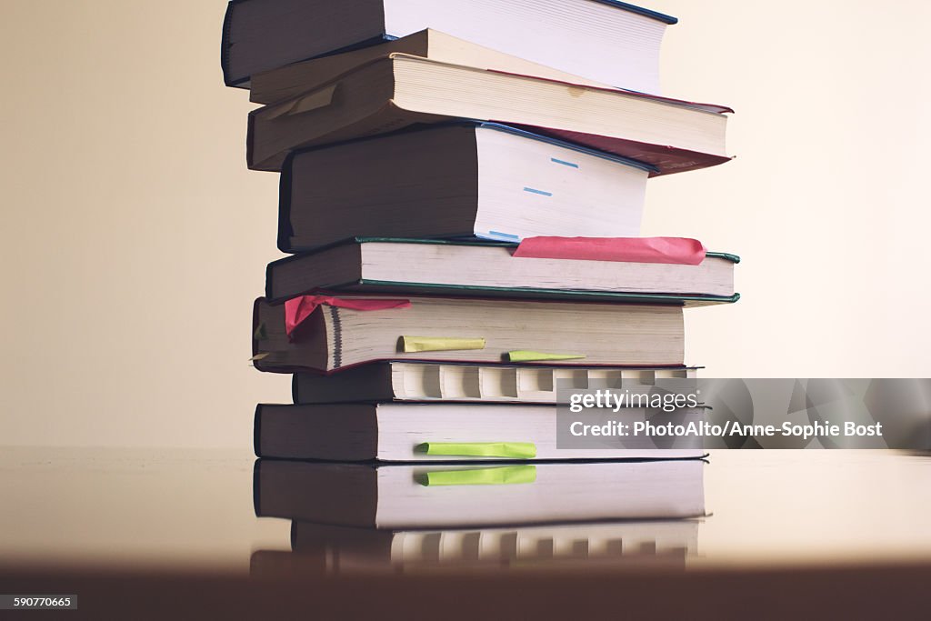 Textbooks stacked on table