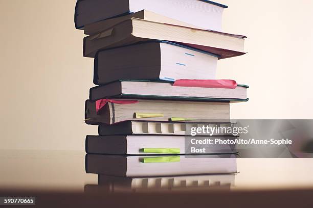textbooks stacked on table - text book stockfoto's en -beelden