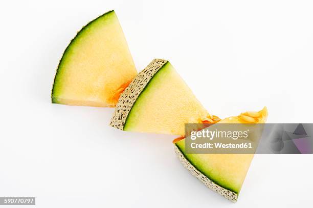 three pieces of galia melon on white ground - gladde meloen stockfoto's en -beelden