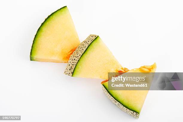 three pieces of galia melon on white ground - honeydew melon stock pictures, royalty-free photos & images