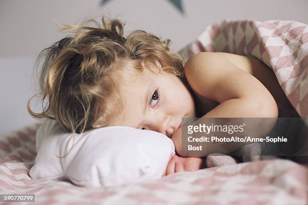 little girl lying down for a nap - sick child stockfoto's en -beelden