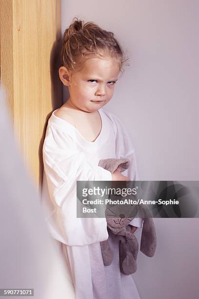 little girl sulking in corner - stubborn stock-fotos und bilder