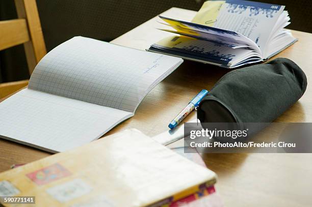 school books and supplies on desk - etui stockfoto's en -beelden