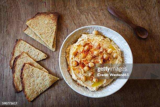 bowl of hummus and flat bread on wood - tahini stock pictures, royalty-free photos & images