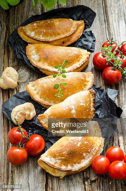 row of five calzone stuffed with tomatoes and sage - calzone stock pictures, royalty-free photos & images