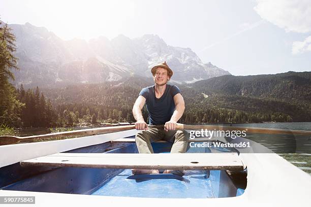 germany, bavaria, eibsee, man in rowing boat on the lake - rowboat stockfoto's en -beelden