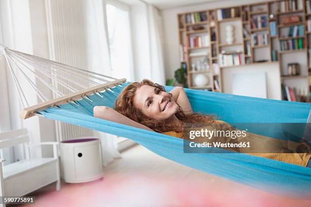 smiling woman at home lying in hammock - inside hammock stock pictures, royalty-free photos & images
