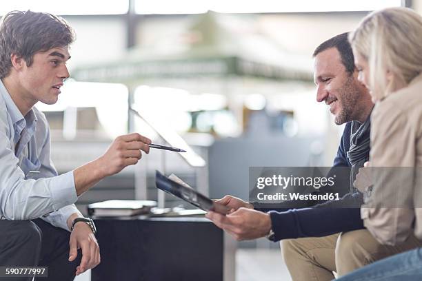 car dealer talking to couple - used car salesman stock pictures, royalty-free photos & images