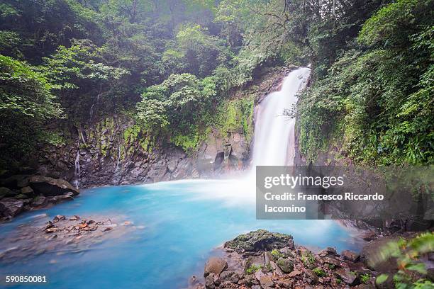 costa rica, rio celeste waterfall - rio azul stock pictures, royalty-free photos & images