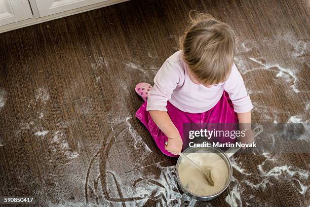 child playing in kitchen floor - dirty pan stock pictures, royalty-free photos & images