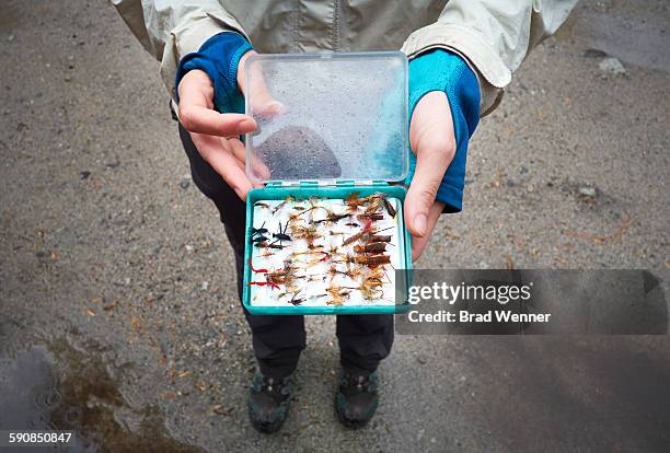 woman holding fly fishing tackle - fishing tackle box stockfoto's en -beelden