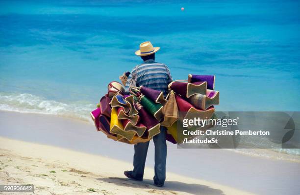 beach vendor with goods to sell - vendedor de puerta en puerta fotografías e imágenes de stock