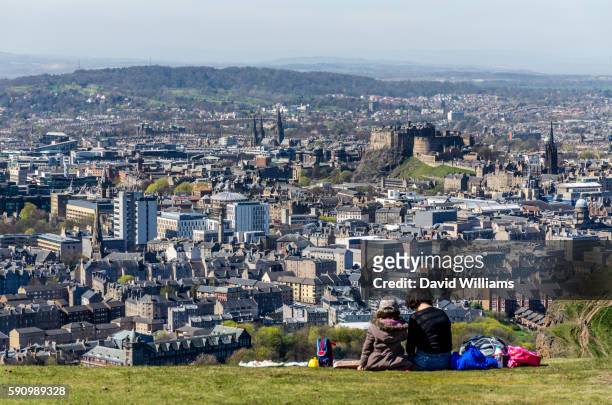 a mother and daughter enjoy a picnic atop of arthur's seat in holyrood park, edinburgh. arthur's sea - arthurs seat stock pictures, royalty-free photos & images