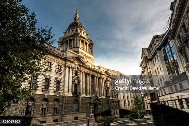 the central criminal court of england and wales known as the old bailey from the street on which it - old bailey stock pictures, royalty-free photos & images