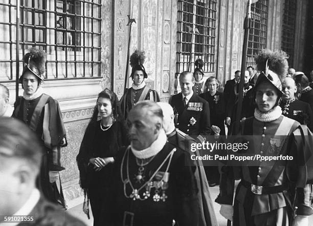 Princess Elizabeth is followed by Prince Philip, Duke of Edinburgh and flanked by Monsignor Nardone as well as Ceremonial Knights of the Cape and...