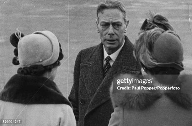 King George VI talks to Princess Margaret and Queen Elizabeth as they prepare to say goodbye to Princess Elizabeth and the Duke of Edinburgh, who are...