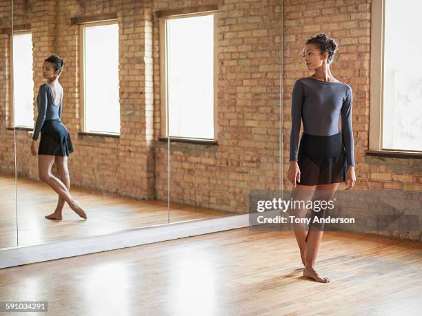 professional dancer warming up before class - haarknoten stock-fotos und bilder