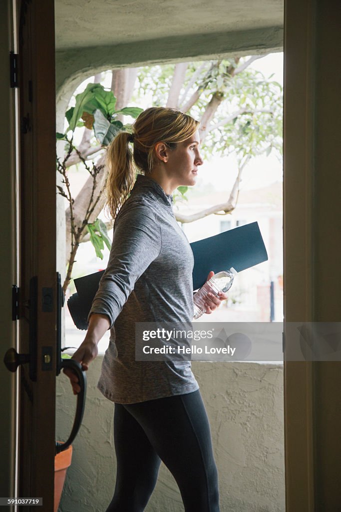 Woman with yoga mat