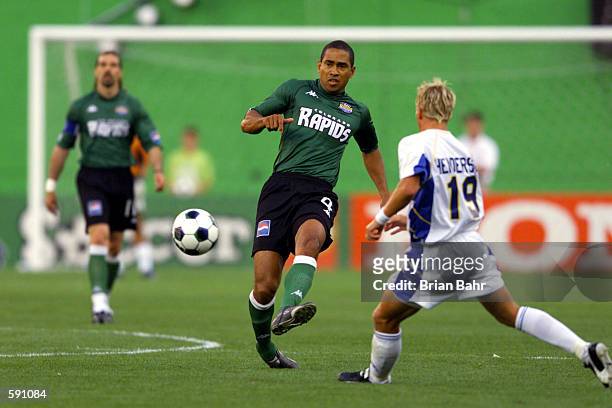 Robin Fraser of the Colorado Rapids dribbles against the defense of the Miami Fusion at Mile High Stadium in Denver, Colorado. The Miami Fusion won 1...