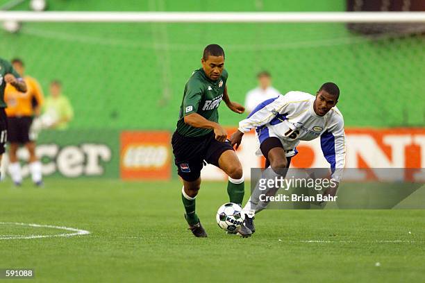 Greg Simmonds of the Miami Fusion and Robin Fraser of the Colorado Rapids fight for possession of the ball during the match at Mile High Stadium in...