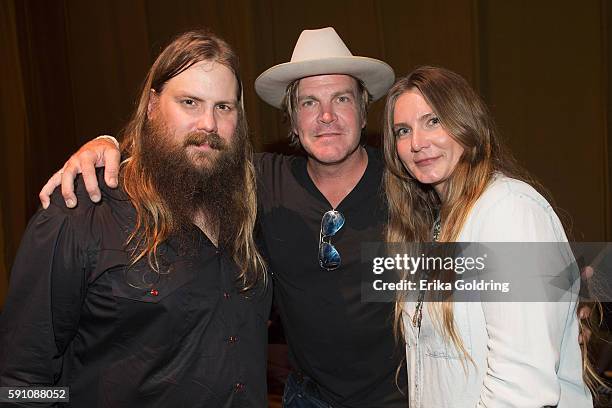 Chris Stapleton, Jack Ingram and Morgane Stapleton gather for a photo backstage at Ryman Auditorium on August 16, 2016 in Nashville, Tennessee.