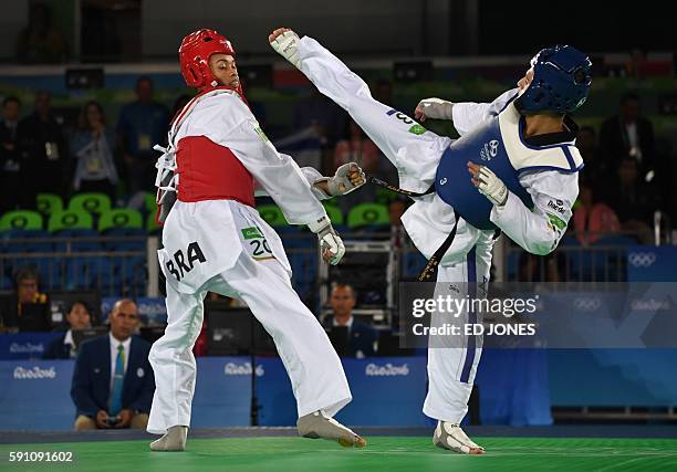 Israel's Ron Atias tries to kick Brazil's Venilton Teixeira during their men's taekwondo qualifying bout in the -58kg category as part of the Rio...