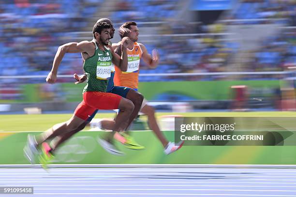 Algeria's Larbi Bourrada and Netherlands' Eelco Sintnicolaas compete in a Men's Decathlon 100m heat during the athletics event at the Rio 2016...