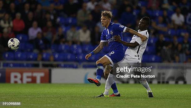 Billy McKay of Oldham Athletic play sthe ball under pressure from Gabriel Zakuani of Northampton Town during the Sky Bet League One match between...