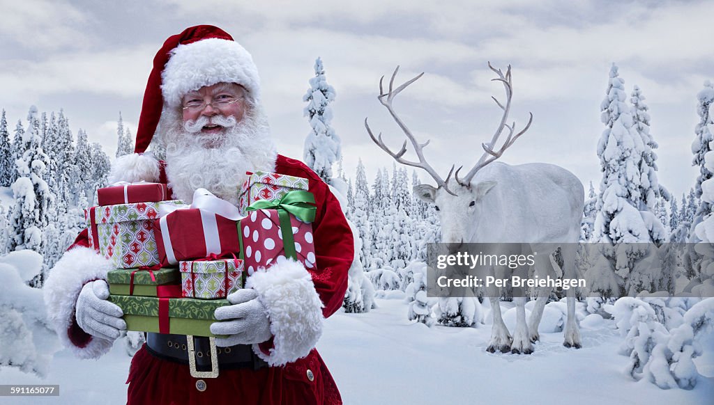 Santa Claus holding gifts with a reindeer