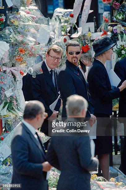 British politician David Trimble and English singer and songwriter George Michael attend the funeral of Diana, Princess of Wales at Westminster Abbey...