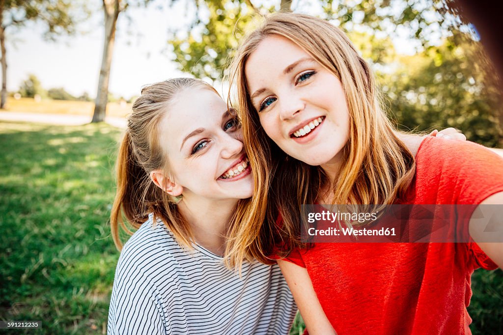 Two happy teenage girls taking a selfie