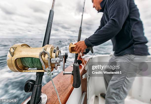 spain, asturias, fisherman on fishing boat on cantabrian sea - cantabrian sea stock pictures, royalty-free photos & images