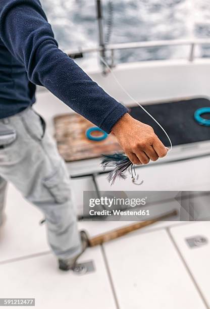 spain, asturias, fisherman holding bait - deep sea fishing stock-fotos und bilder